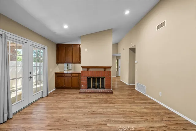 a view of kitchen with wooden floor and electronic appliances