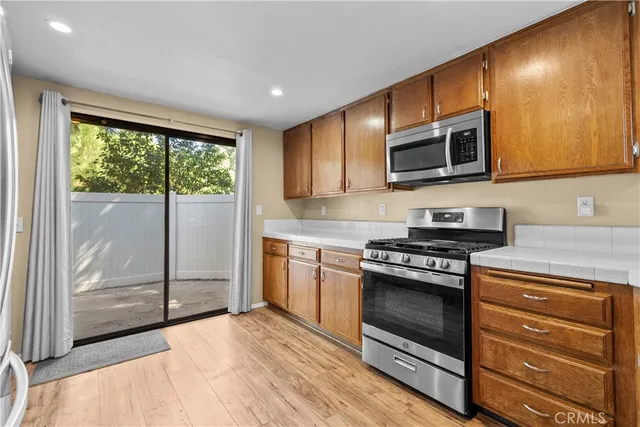 a kitchen with stainless steel appliances granite countertop a stove microwave and cabinets