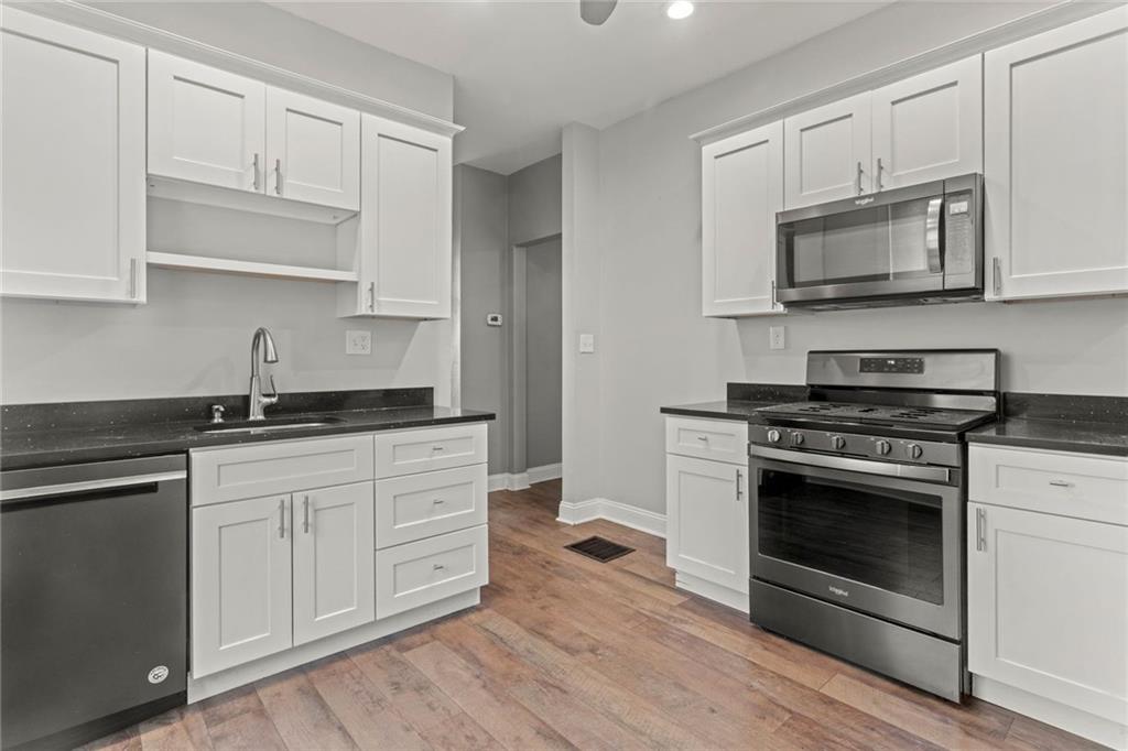 751 Florence Avenue Pittsburgh, PA 15202 - Photo 11 of 45 a kitchen with white cabinets stainless steel appliances and sink