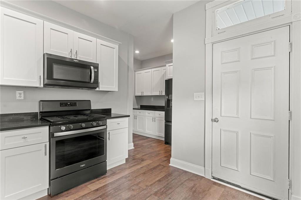 751 Florence Avenue Pittsburgh, PA 15202 - Photo 16 of 45 a kitchen with stainless steel appliances white cabinets and a stove top oven