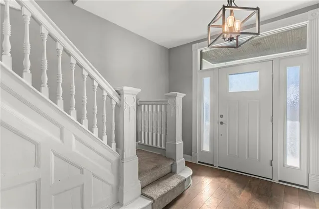 a view of staircase with railing and white walls