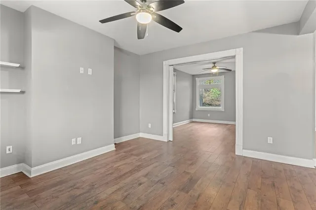 wooden floor in an empty room with a window