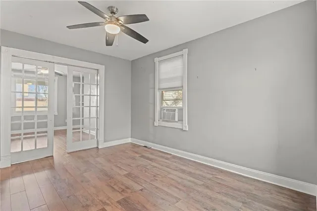 wooden floor in an empty room with a window
