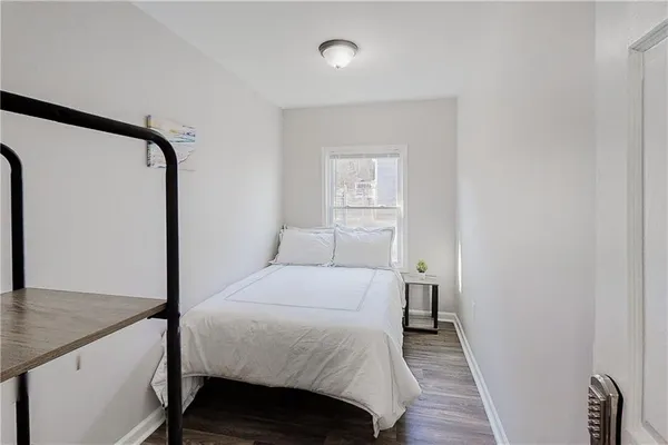 a bedroom with a bed and a mirror