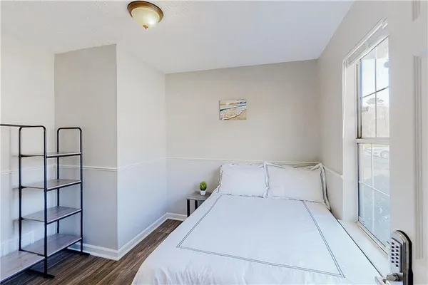 a bedroom with a bed and window