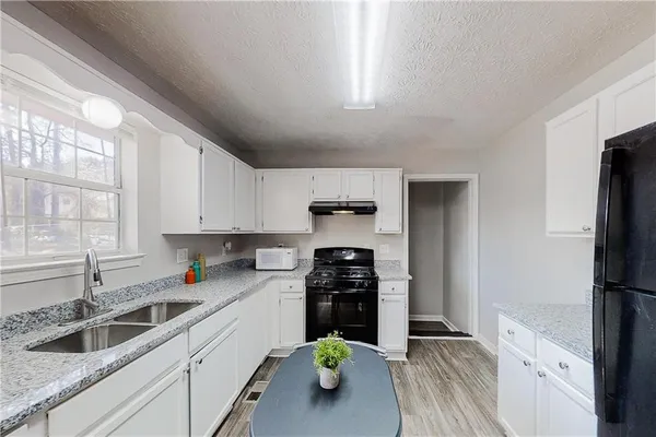 a kitchen with a refrigerator a sink and a stove
