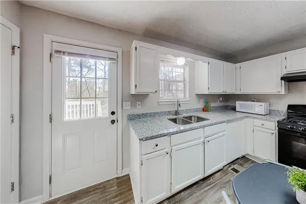 a kitchen with a sink window and cabinets