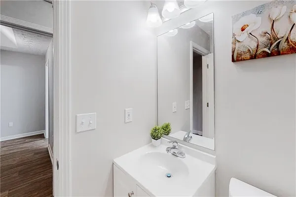 a bathroom with a sink a mirror and vanity
