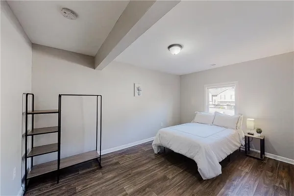 a bedroom with a bed and a window