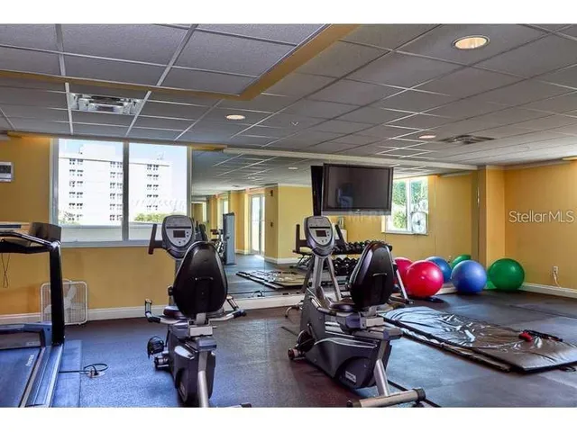 a room with gym equipment and view of living room
