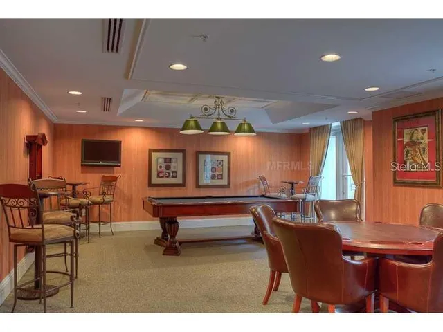 a living room with furniture a large window and flat screen tv