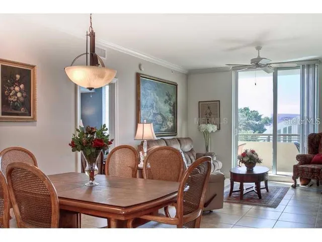 a dining room with furniture a chandelier and window