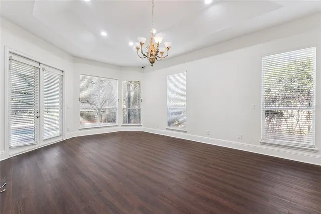 a spacious bathroom with a tub sink and mirror