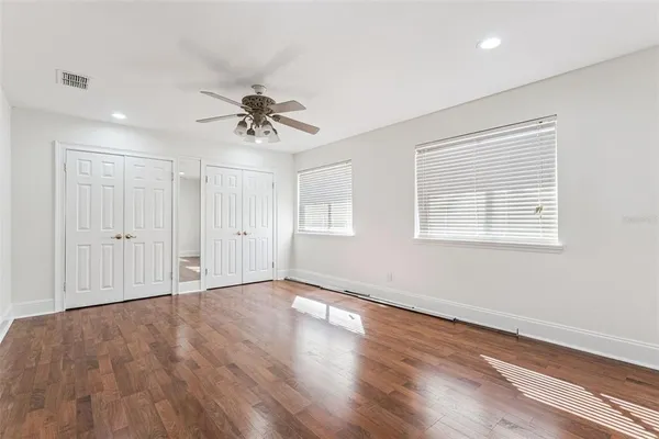 a view of a hallway with windows and cabinet