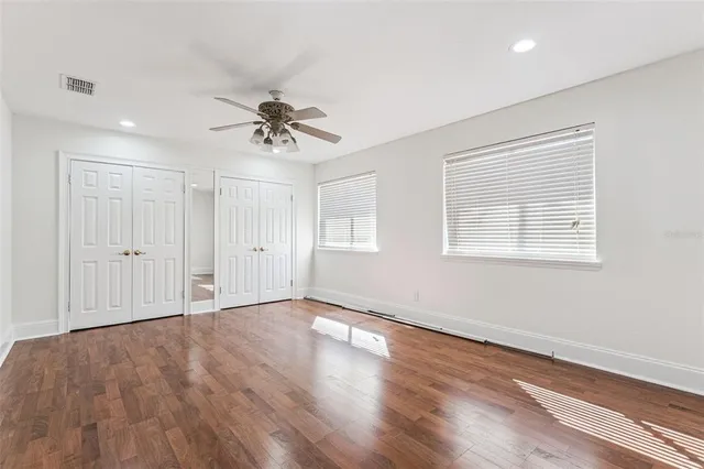 a view of a hallway with windows and cabinet