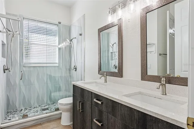 a bathroom with a toilet a sink and a mirror