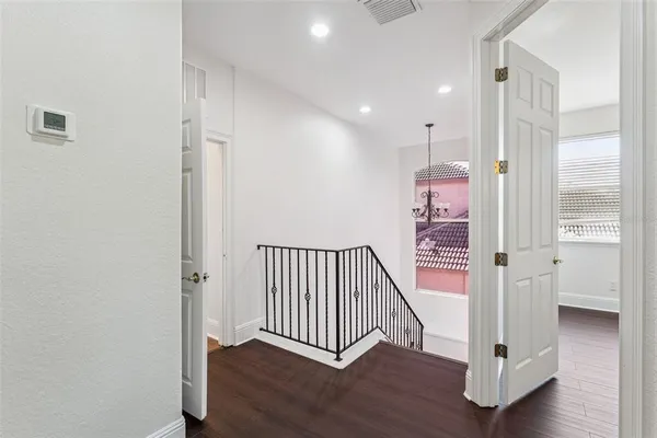 a view of a white building with swimming pool in front of it