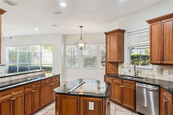 a kitchen with granite countertop a sink and a window