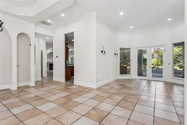 a kitchen with kitchen island granite countertop a sink and a refrigerator