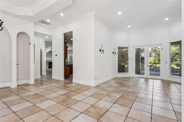 a kitchen with kitchen island granite countertop a sink and a refrigerator