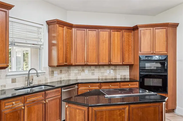 a view of a hallway with windows and chandelier