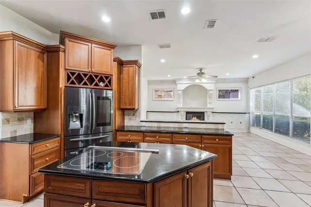 a view of an empty room with a fireplace and a large window
