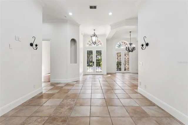 a view of kitchen with refrigerator and cabinets
