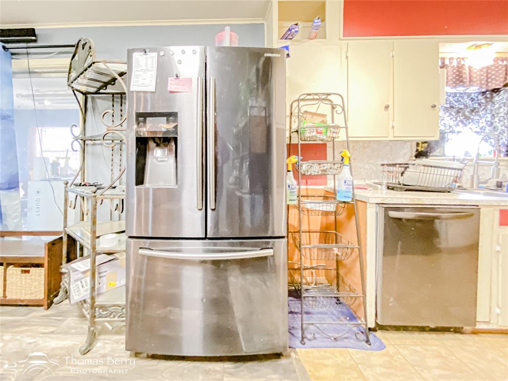 1029 Northwest 3rd Street Hamlin, TX 79520 - Photo 13 of 35 a view of a kitchen with a stove top oven and sink