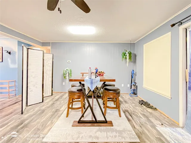 a dining room with furniture and wooden floor