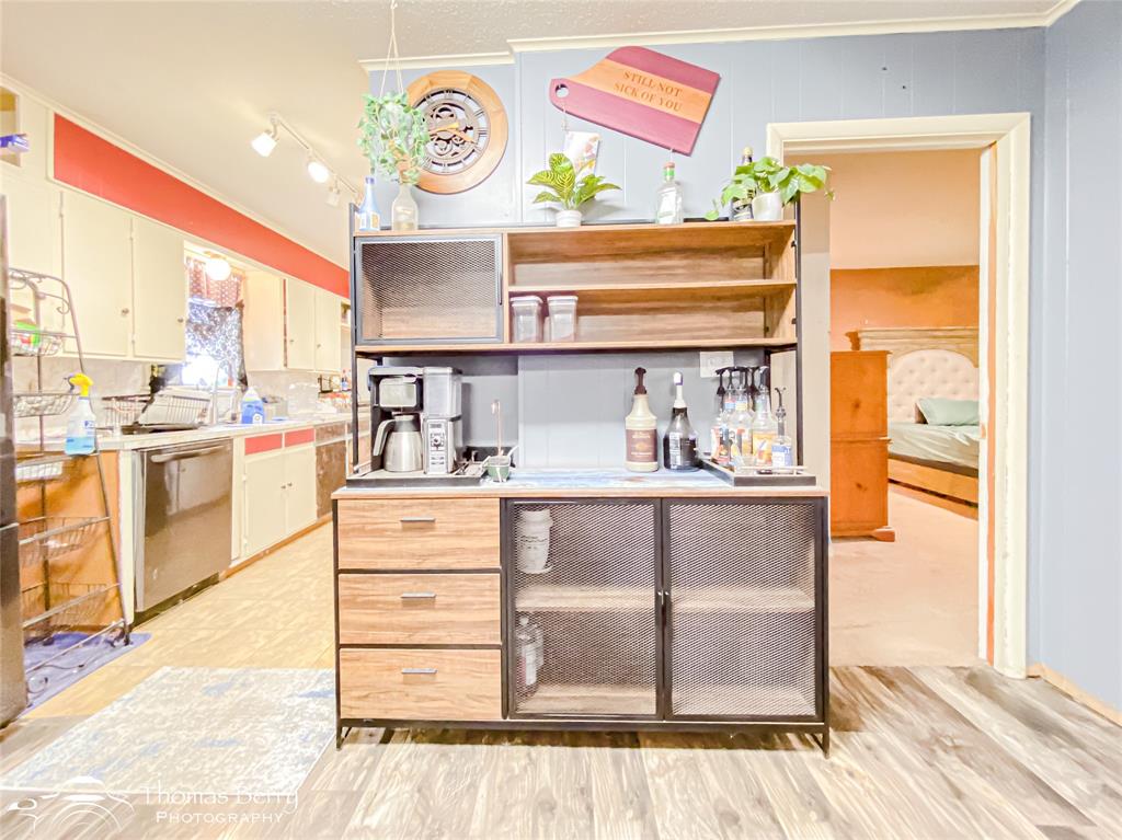 1029 Northwest 3rd Street Hamlin, TX 79520 - Photo 18 of 35 a kitchen with stainless steel appliances cabinets and a large window