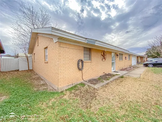 a front view of a house with swimming pool and sitting space