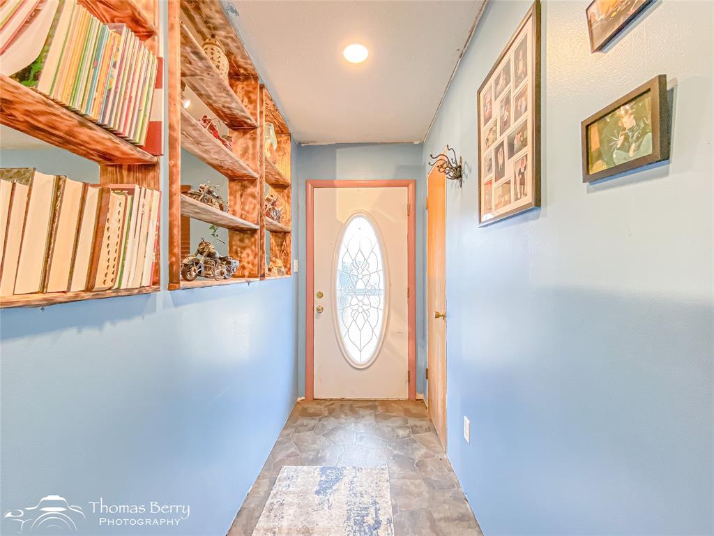1029 Northwest 3rd Street Hamlin, TX 79520 - Photo 5 of 35 a view of an entryway with wooden floor