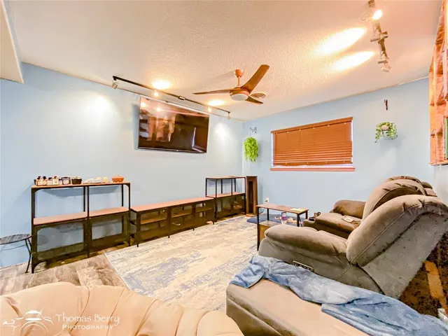 a lobby with furniture and a flat screen tv