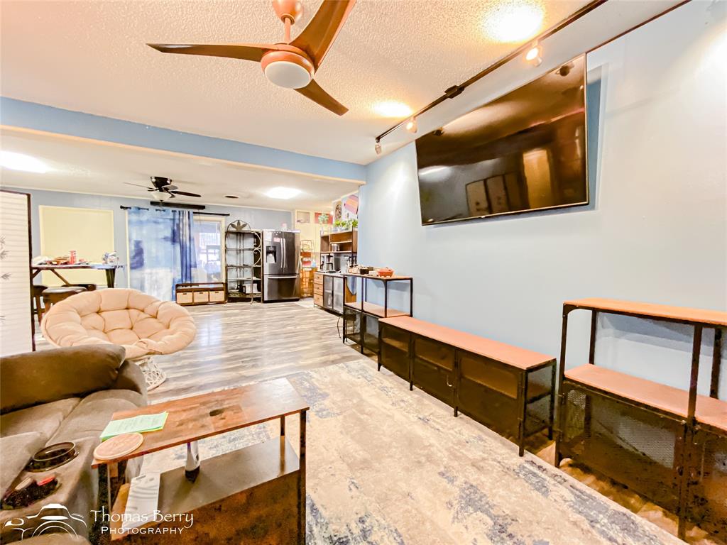 1029 Northwest 3rd Street Hamlin, TX 79520 - Photo 7 of 35 a lobby with furniture and a flat screen tv