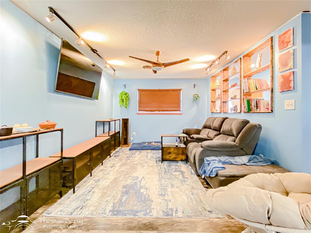 1029 Northwest 3rd Street Hamlin, TX 79520 - Photo 9 of 35 a living room with furniture window and a wooden floor