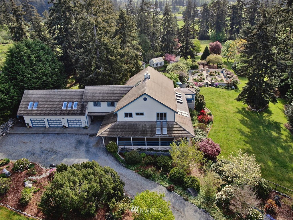 5741 Crow Haven Road Langley, WA 98260 - Photo 2 of 40 an aerial view of a house with a yard and large trees