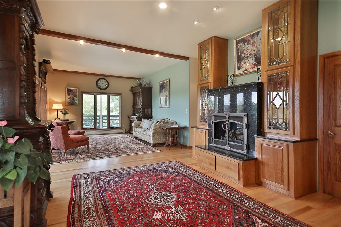 5741 Crow Haven Road Langley, WA 98260 - Photo 12 of 40 a living room with furniture a rug and a fireplace