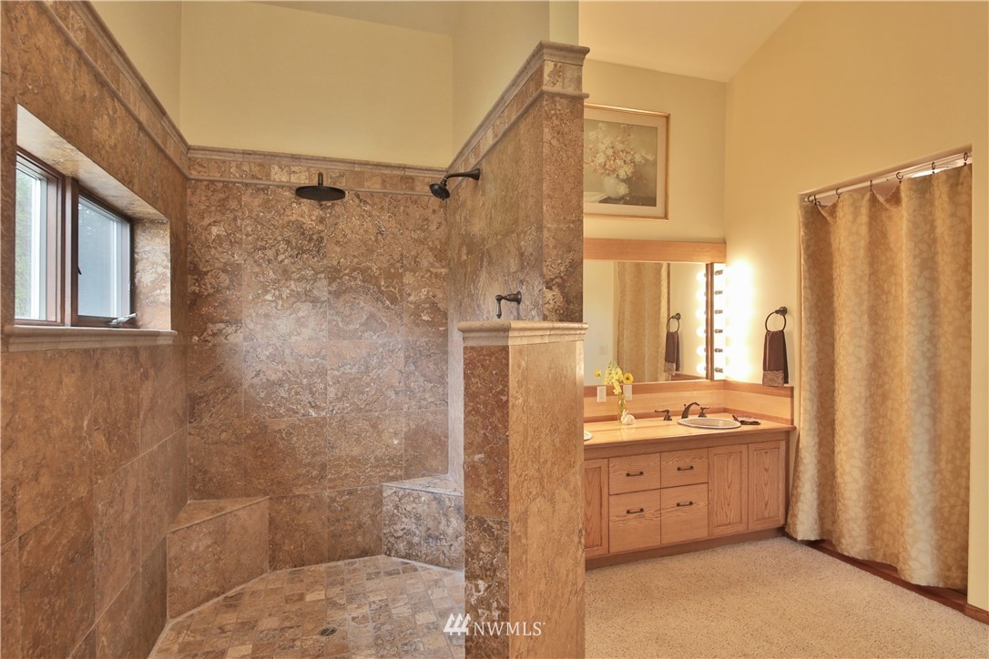 5741 Crow Haven Road Langley, WA 98260 - Photo 20 of 40 a bathroom with a double vanity sink toilet and shower