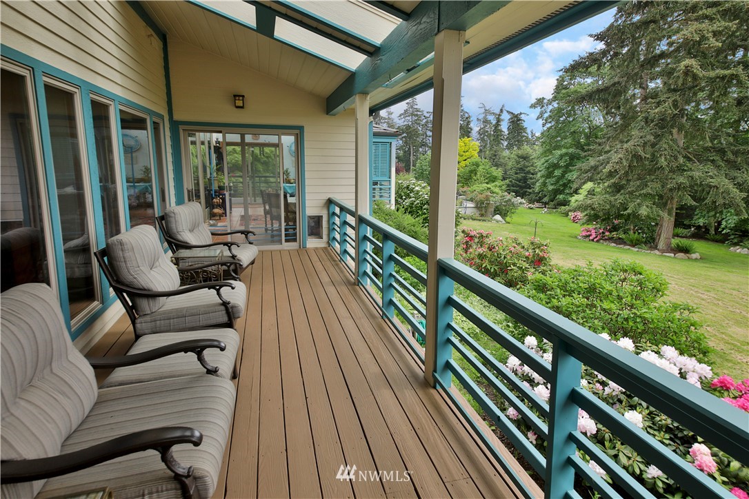 5741 Crow Haven Road Langley, WA 98260 - Photo 26 of 40 a balcony with wooden floor and outdoor seating