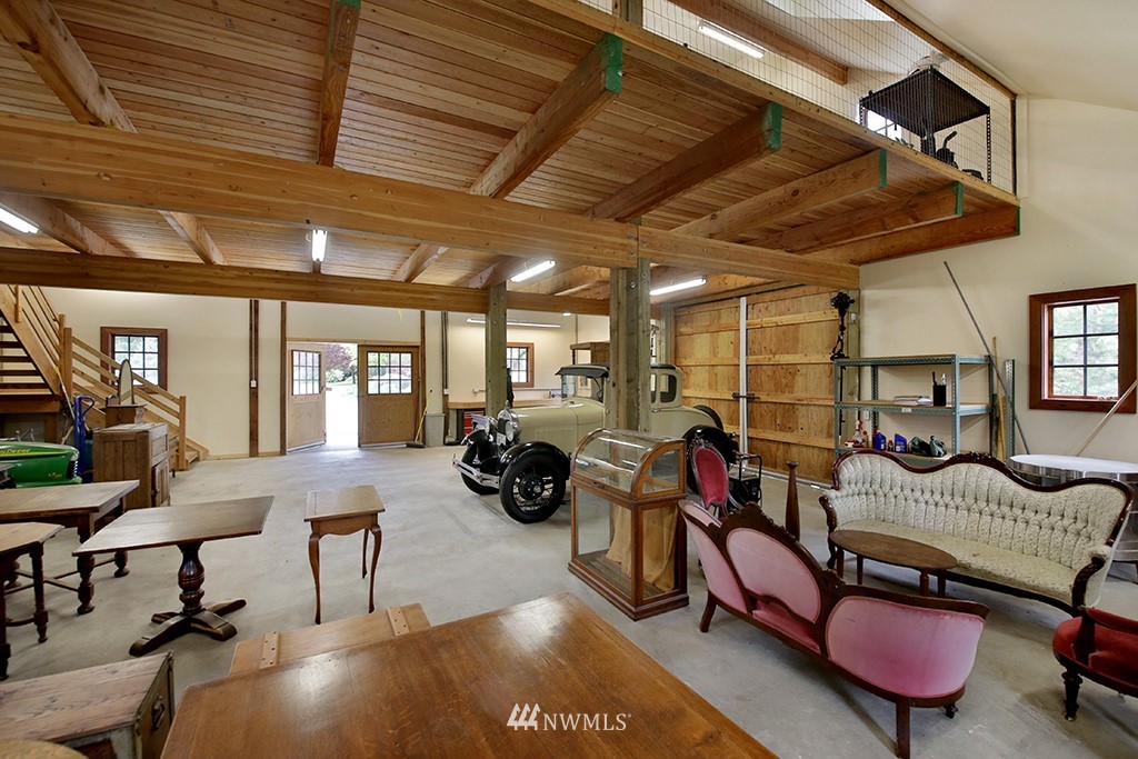 5741 Crow Haven Road Langley, WA 98260 - Photo 30 of 40 a living room with furniture a rug and a chandelier