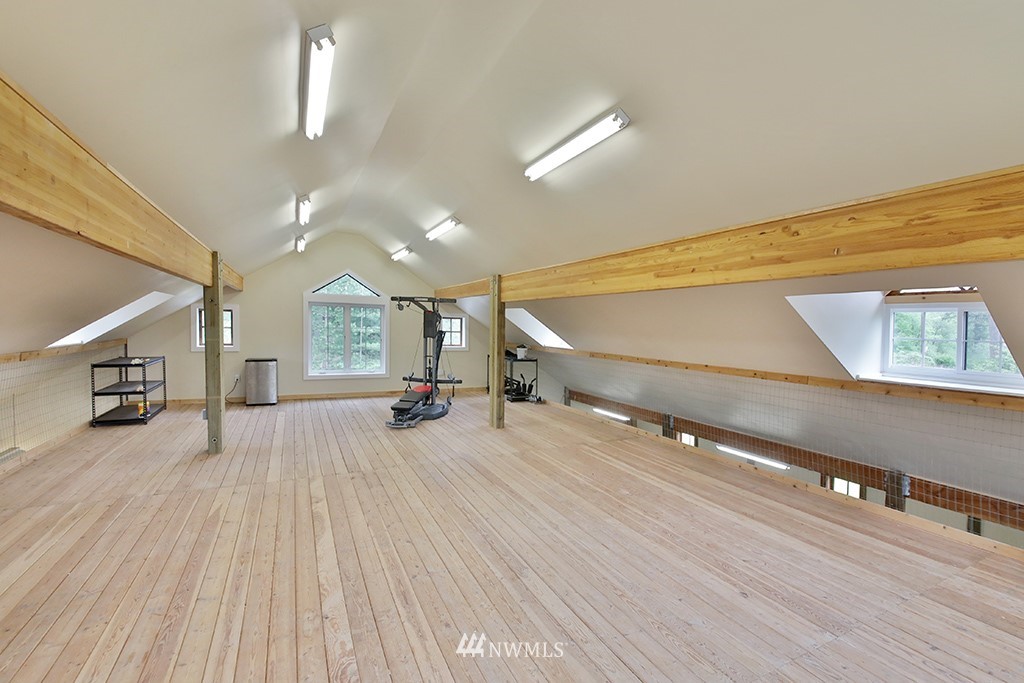 5741 Crow Haven Road Langley, WA 98260 - Photo 31 of 40 a big room with wooden floor and windows
