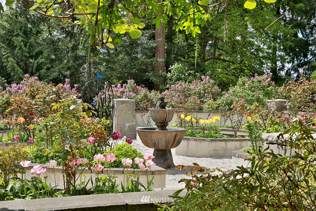 5741 Crow Haven Road Langley, WA 98260 - Photo 38 of 40 a view of a fountain in the yard with potted plants