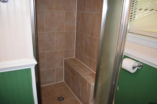 a room with wooden floor and a window