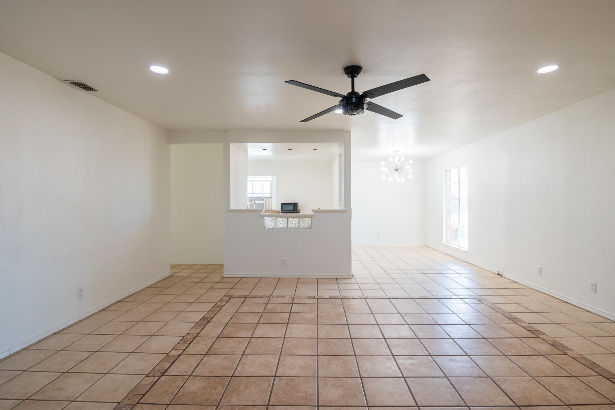6917 Highway 114 Lubbock, TX 79407 - Photo 18 of 45 a view of a livingroom with a ceiling fan and window