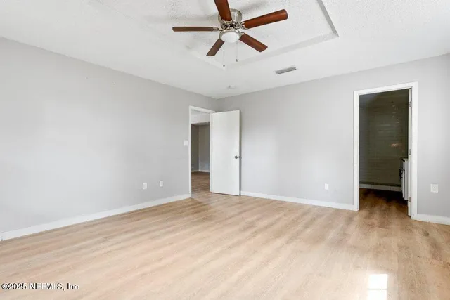 a view of a room with a ceiling fan