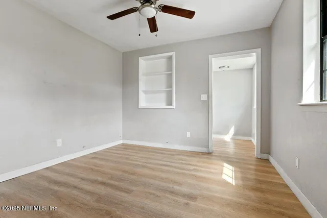 wooden floor in an empty room with a window