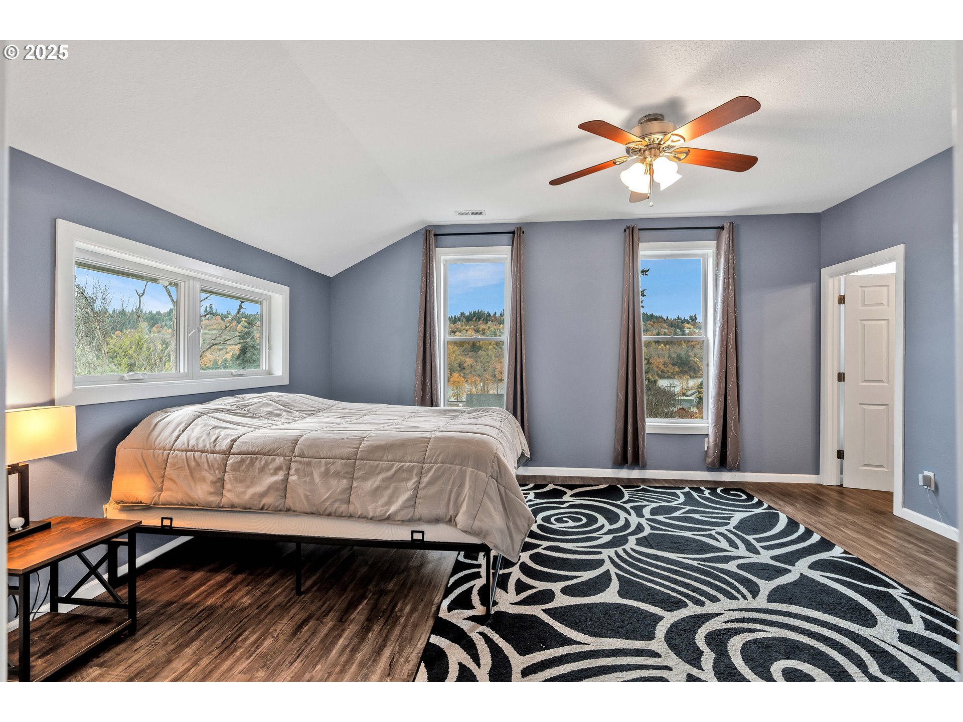 704 3rd Avenue Oregon City, OR 97045 - Photo 22 of 48 a bedroom with a bed and a chandelier