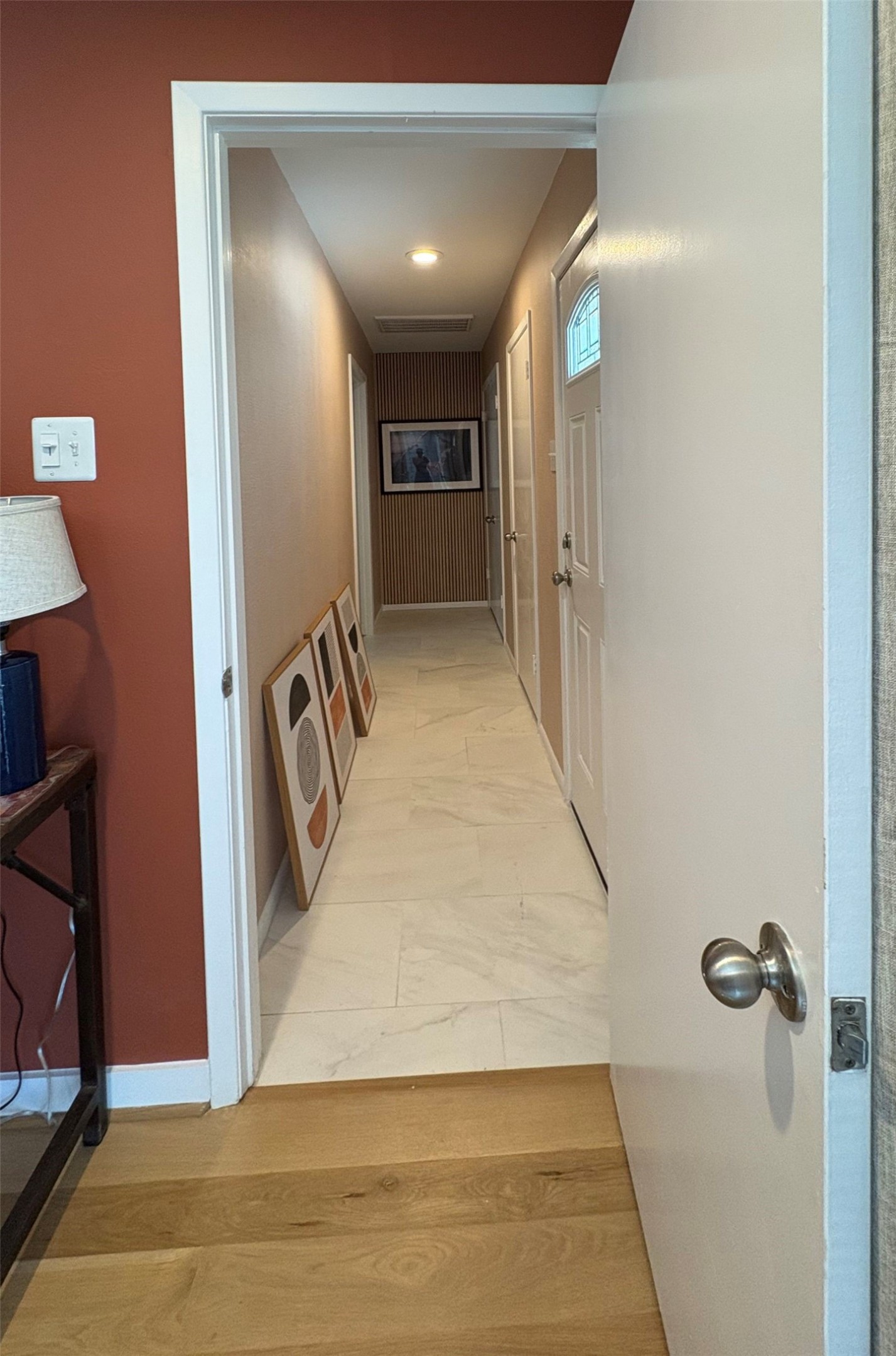 5626 Jason Street Houston, TX 77096 - Photo 4 of 13 a view of a hallway with wooden floor and staircase