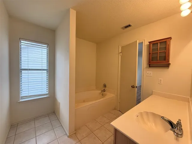 a bathroom with a bathtub and shower