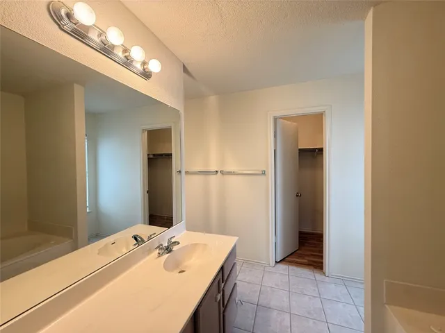 a bathroom with a sink a mirror and a shower